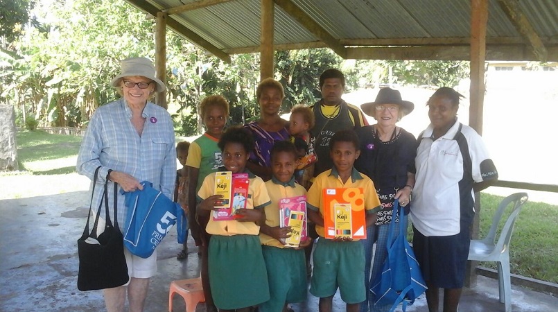 Elaine Handford (left) and Janet Kaine (second right) with the children and their gifts