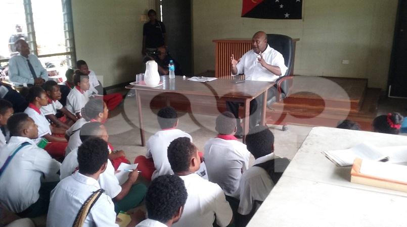Students listening to Justice Mogish during the court user forum in Bereina, Central Province.
