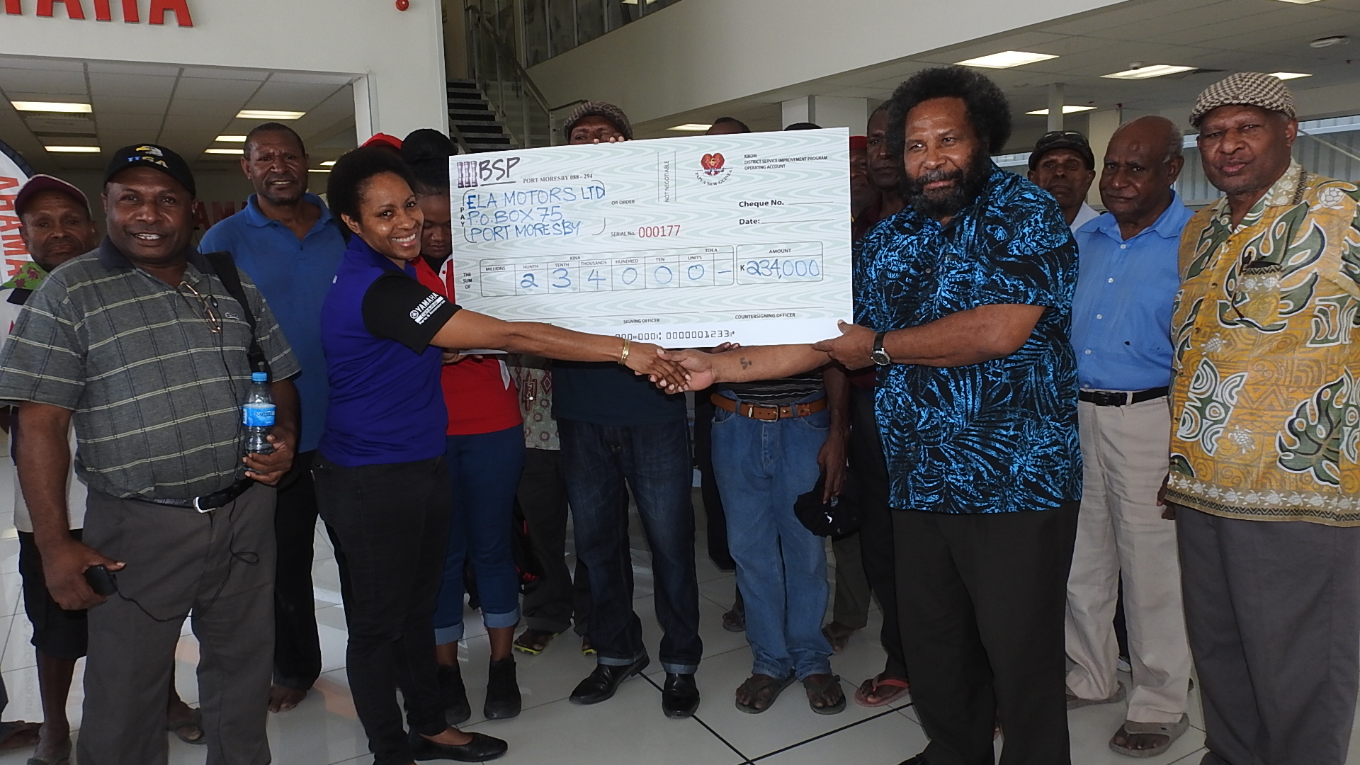 Presenting a dummy cheque to Ela Motors