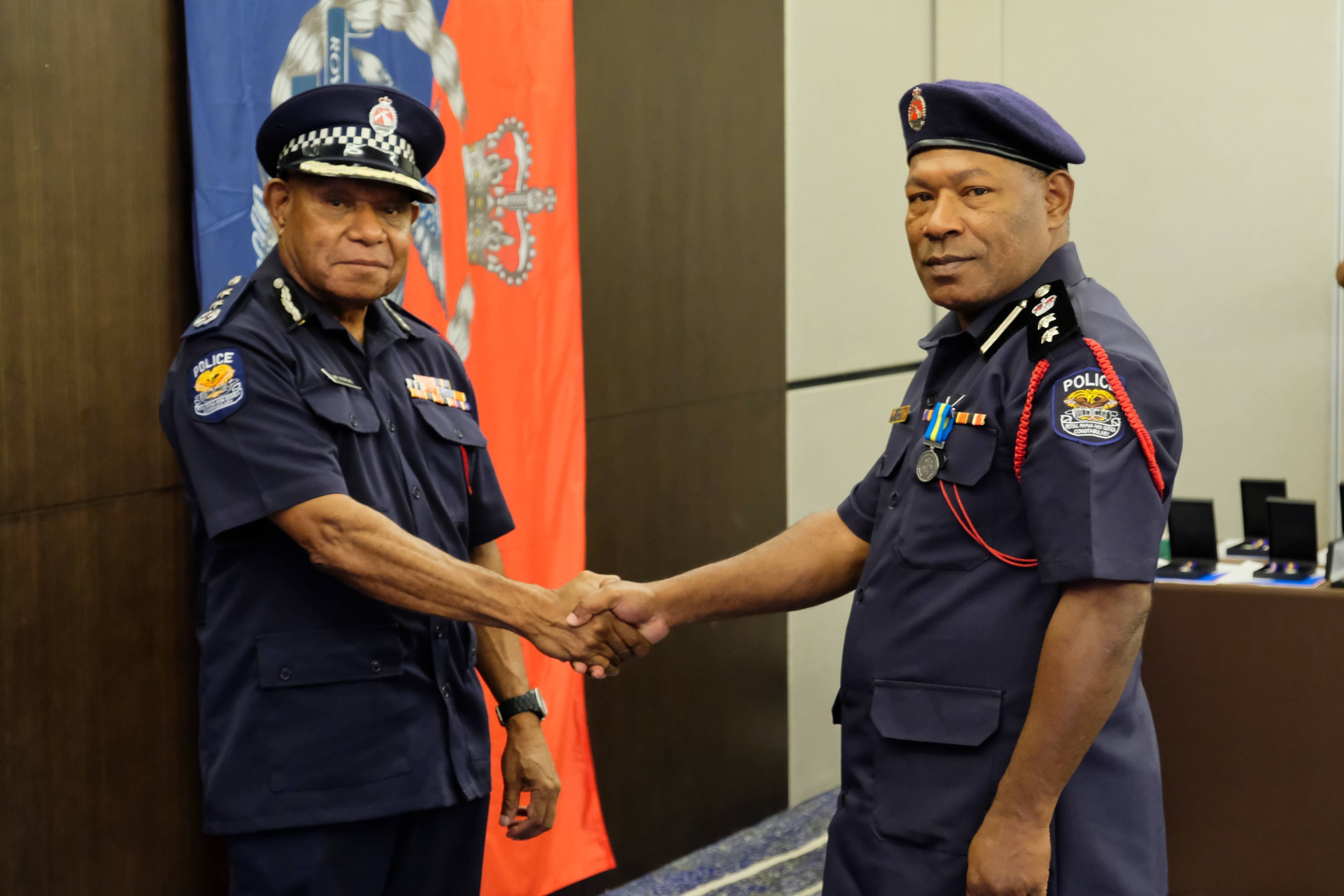 Deputy Commissioner and Chief of Police Operations presenting the Royal Solomon Islands Police&#039;s International Law Enforcement Cooperation Medal to Chief Superintendent John Kolopen, Director of the RPNGC Community Policing Directorate