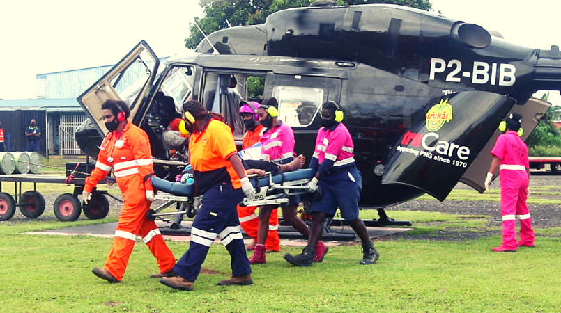 Manolos staff transferring a patient from the helicopter to the ambulance