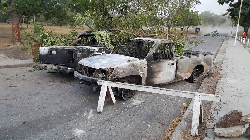 Burnt UPNG vehicles used to barricade the road leading into the main Waigani campus.