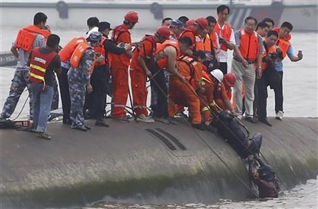 Rescuers save a survivor from the overturned passenger ship