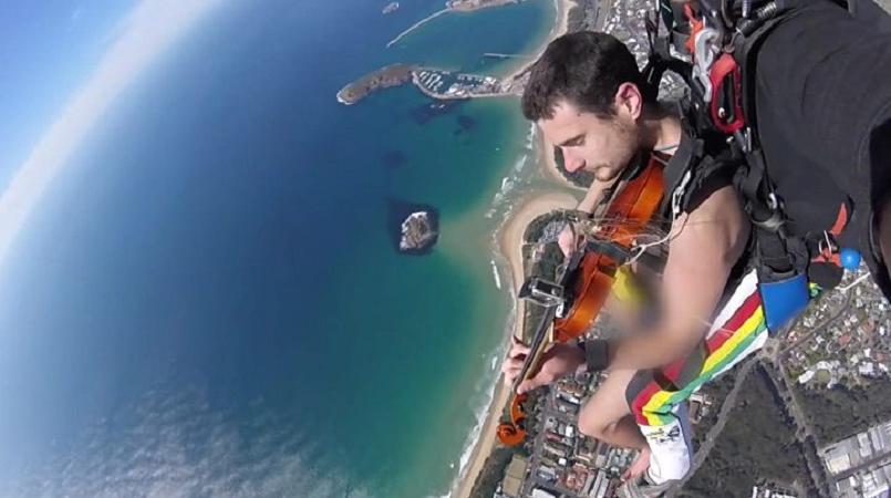 Musician sky dives playing the violin in the nude for men 